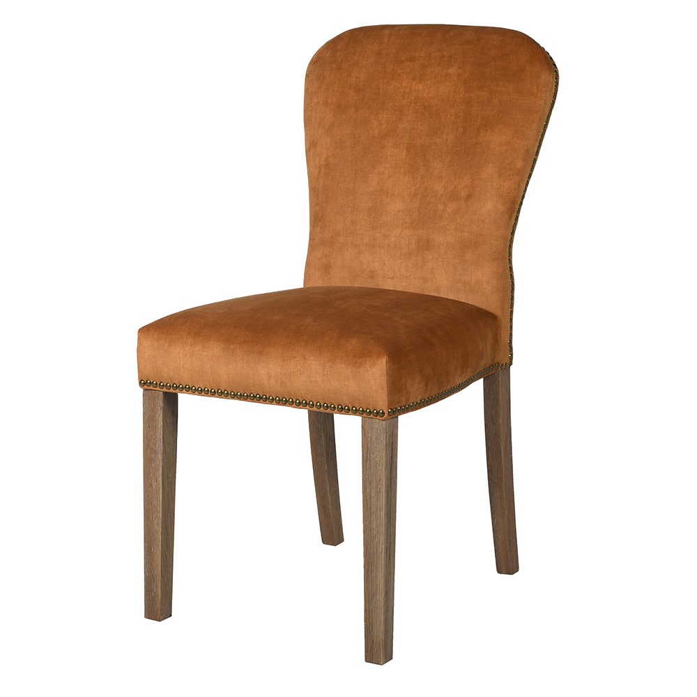 A stunning velvet chair in the warmest most beautiful tone of orange with brass stud detailing.