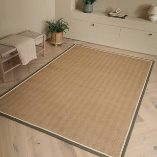 Bordo herringbone jute rug in khaki and cream styled in a living room