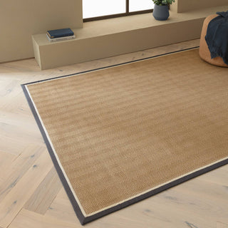 Bordo herringbone jute rug in slate and cream styled in a living room