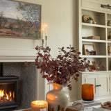 Faux burgundy eucalyptus stem styled in neutral living room
