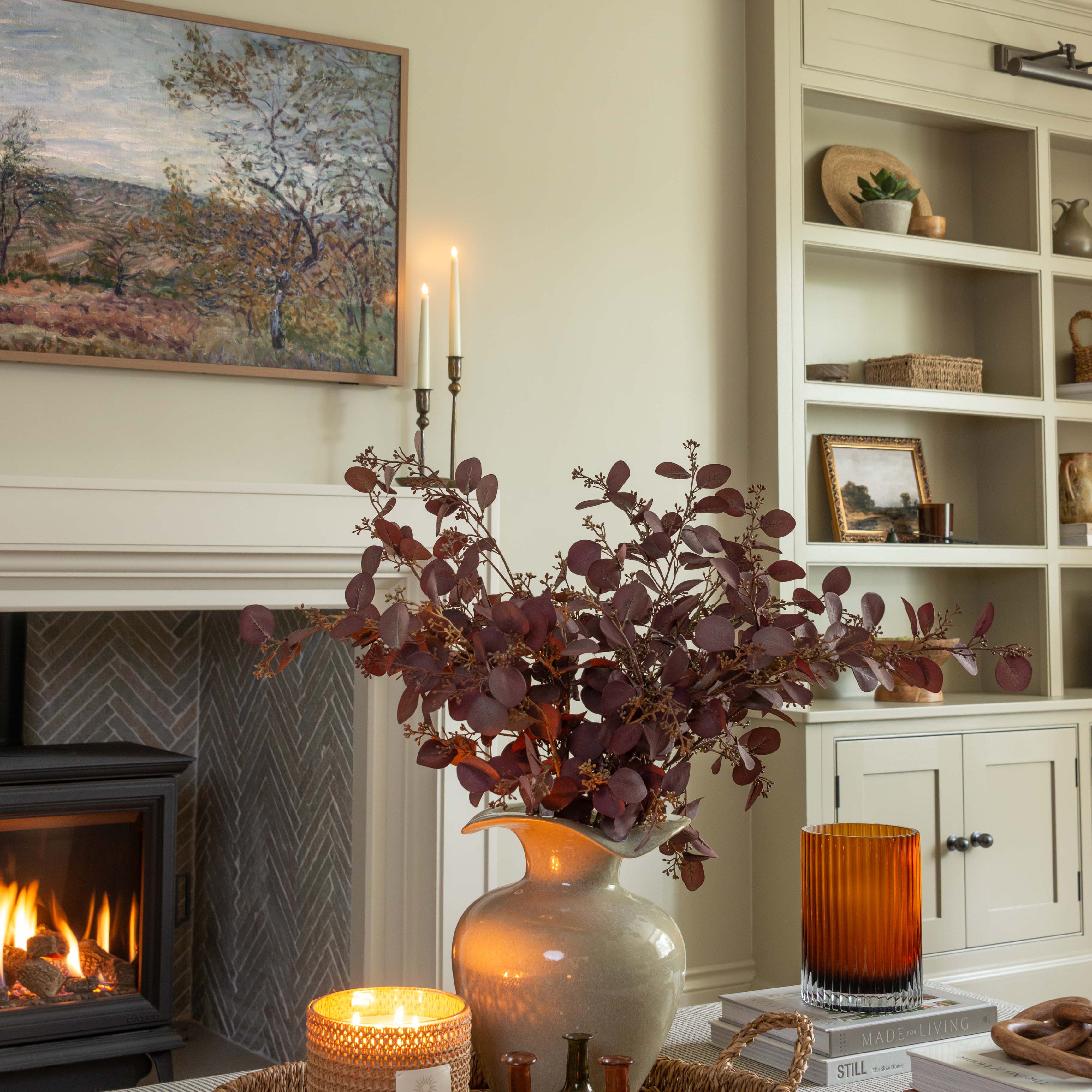 Faux burgundy eucalyptus stem styled in neutral living room
