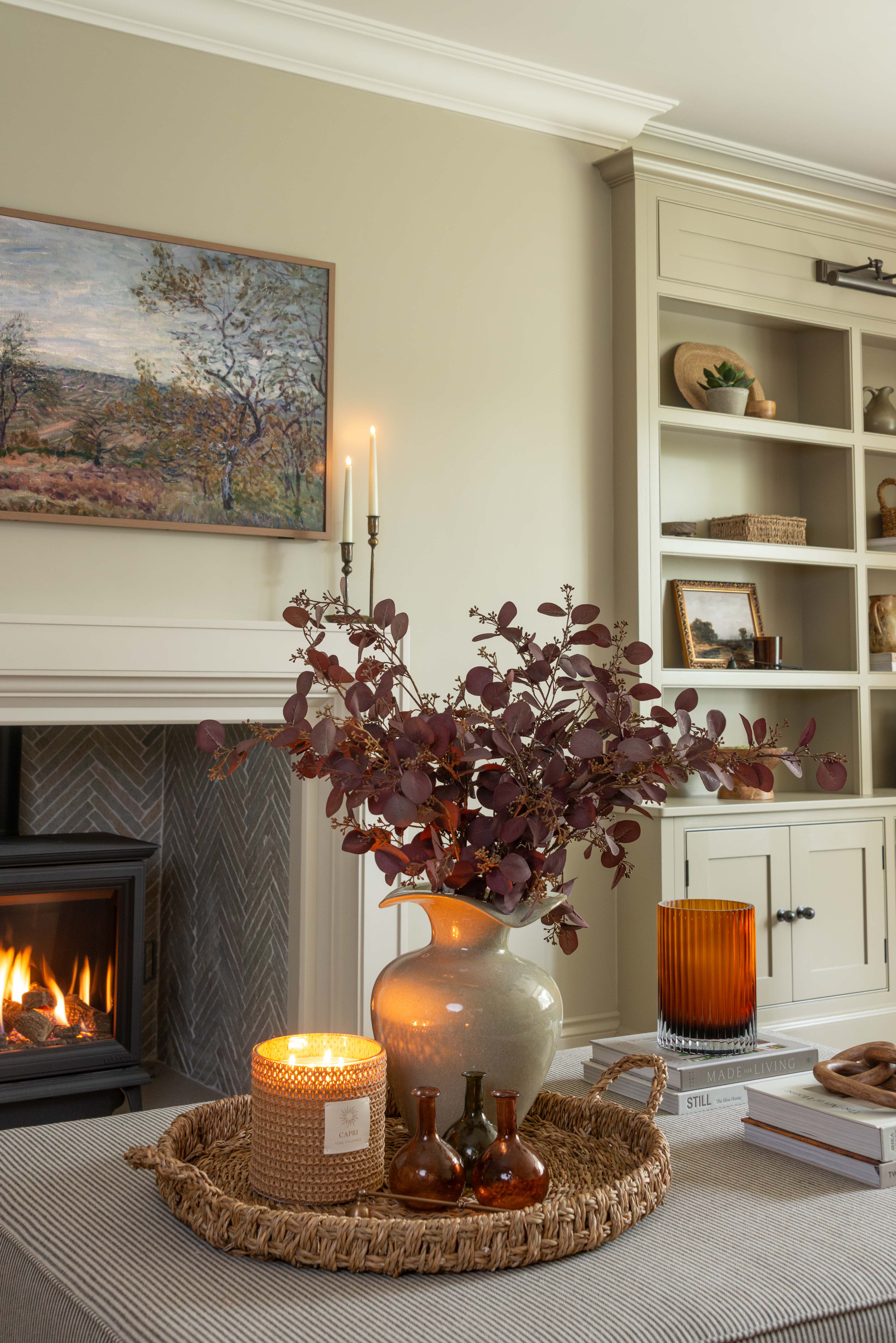 Faux burgundy eucalyptus stem styled in neutral living room
