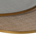 Close up of the rattan top of the smaller table showing through the glass of the larger table