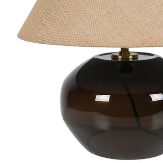 brown glass table lamp with a beige lampshade on a white background