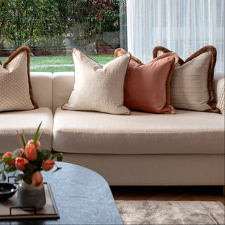 Aldworth champagne cushion layered with neutral cushions