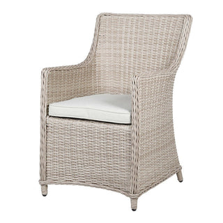 Wicker armchair with a white cushion on a white background