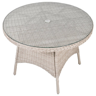 Round wicker table with glass top on a white background