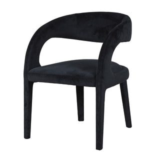 Black velvet dining chair on a white background