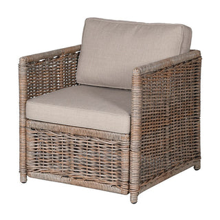 Wicker armchair with beige cushions on a white background