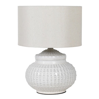 White textured table lamp with a white shade on a white background