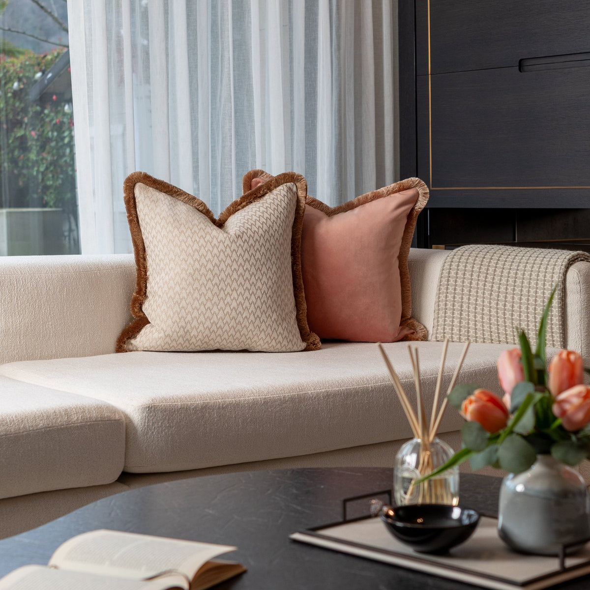 Lechlade gold fringe cushion styled on a sofa