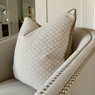 Close up of the woven geometric front and caramel piping on the Lechlade cushion