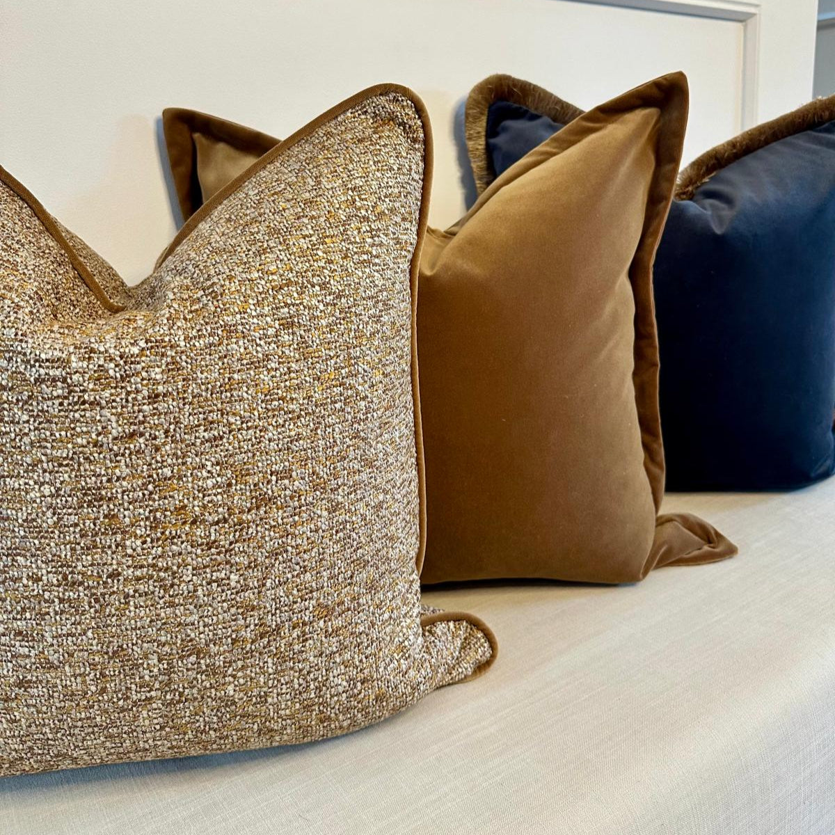 Sherston ochre cushion styled on a sofa