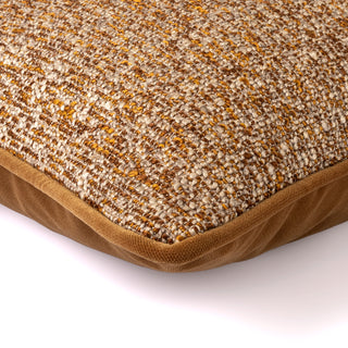 Sherston cushion with ochre piping, angled view