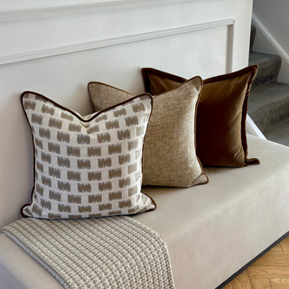 Wellow gold cushion styled on a bench