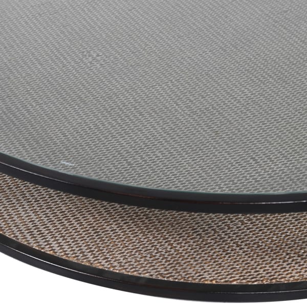 Close up picture of the glass top and rattan shelf