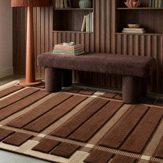 Fable hand tufted wool rug in chocolate styled in a living room
