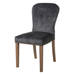 A stunning velvet chair in rich charcoal with brass stud detailing.