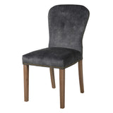 A stunning velvet chair in rich charcoal with brass stud detailing.