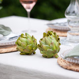 A set of three decorative faux green artichokes.