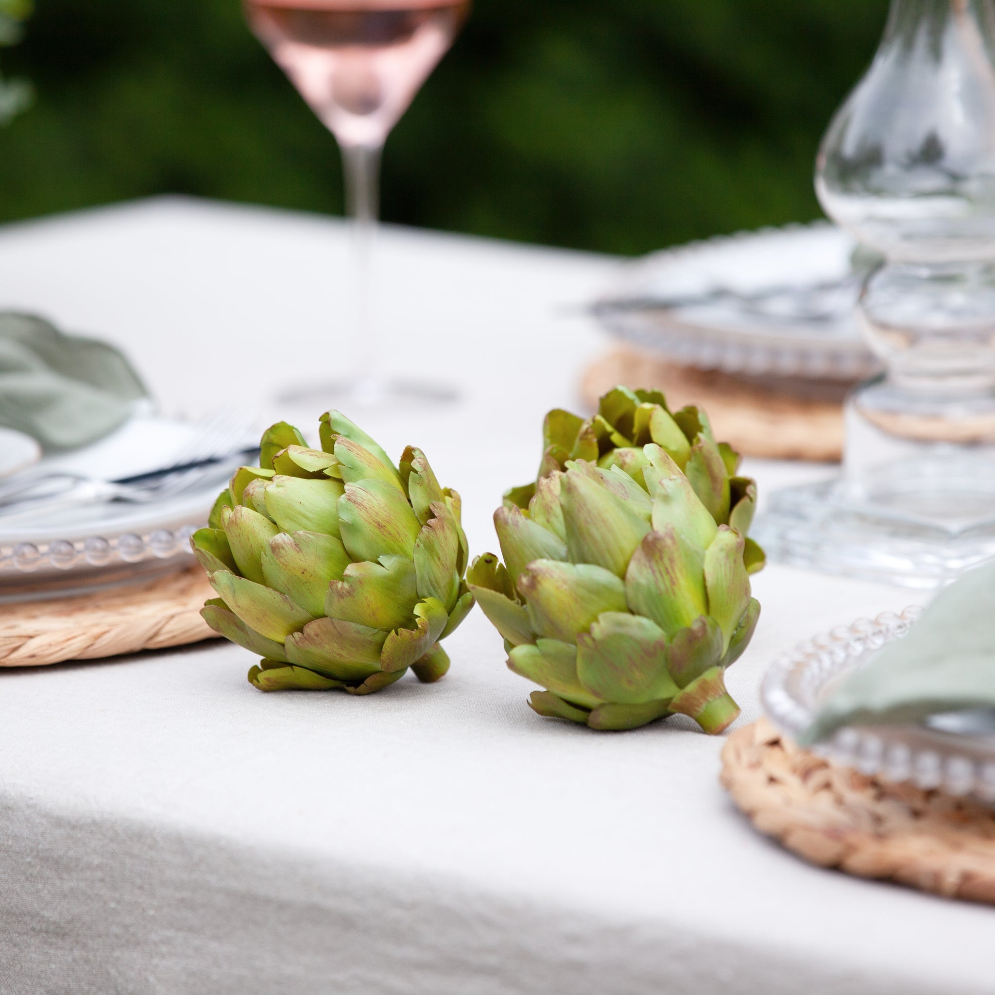A set of three decorative faux green artichokes.