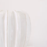 Textured off white glazed ceramic with ridged detail.