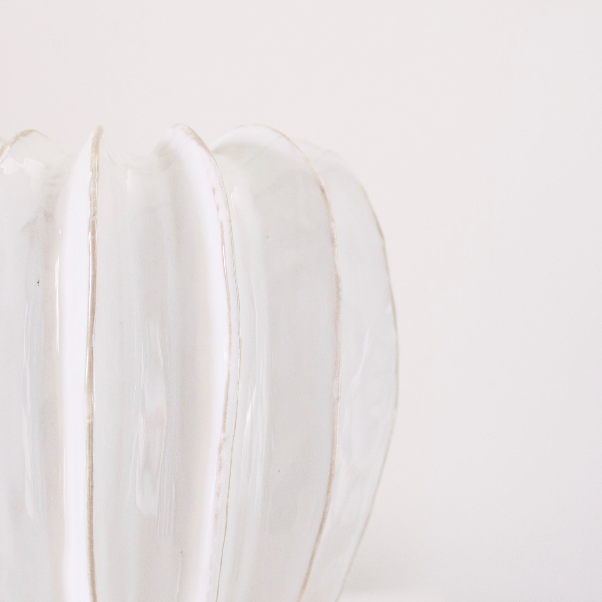 Textured off white glazed ceramic with ridged detail.