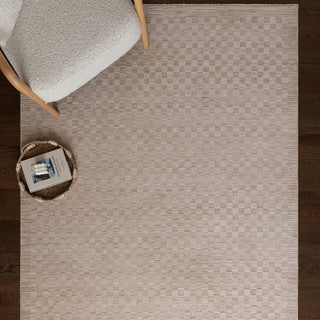 Laurent textured rug in beige styled in a living room