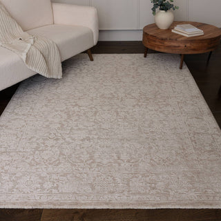 Laurent textured rug in beige and natural styled in a living room