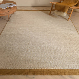 Lima handwoven wool rug in gold styled in a living room