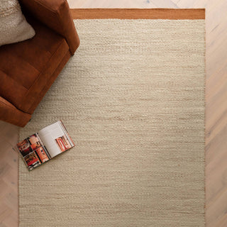 Lima handwoven wool rug in rust styled in a living room