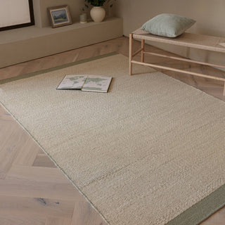 Lima handwoven wool rug in sage styled in a living room