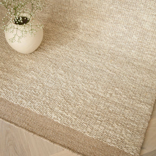 Close-up of the hand-spun wool texture on the Lima rug in sand