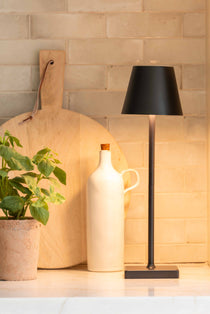 The luxurious Maja Wireless Lamp in sleek black iron boasts a wireless design and can operate for up to 6-16 hours after only 4-6 hours of charging. Its elegant USB-C cable is included for convenience, making it perfect for elevating any space in your home without the need for a plug socket.