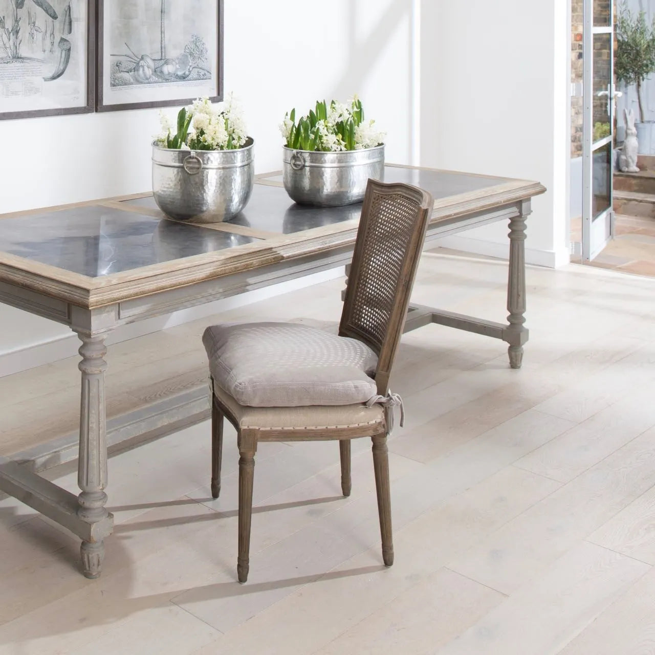 A gorgeous bergère-backed dining chair with an upholstered seat