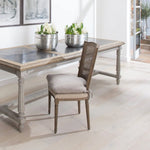 A gorgeous bergère-backed dining chair with an upholstered seat