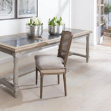 A gorgeous bergère-backed dining chair with an upholstered seat