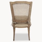 A gorgeous bergère-backed dining chair with an upholstered seat
