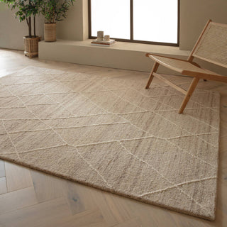 Noah hand tufted wool rug in natural styled in a living room