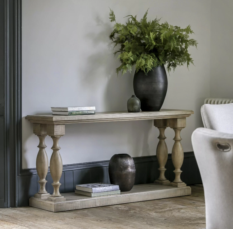 Elevate your home décor with this beautifully crafted rustic pine console table, designed to bring timeless elegance and natural charm to your space. Featuring a weathered finish and classic turned legs, this versatile table blends traditional craftsmanship with modern sophistication. Ideal for hallways, living rooms, or entryways, its spacious double-tiered surface provides ample room for styling with decorative vases, books, or greenery. Whether used as a stylish hallway table or a practical sofa back pie