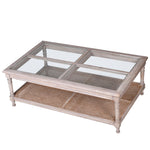 This coffee table is crafted from acacia wood with a rattan and glass top.