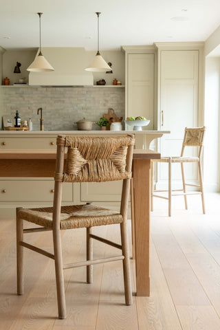 Kitchen with wooden table and chairs, light-colored cabinets, and a neutral color palette.