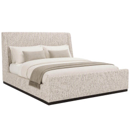 Idbury upholstered king size bed with tall angled headboard in textured neutral fabric