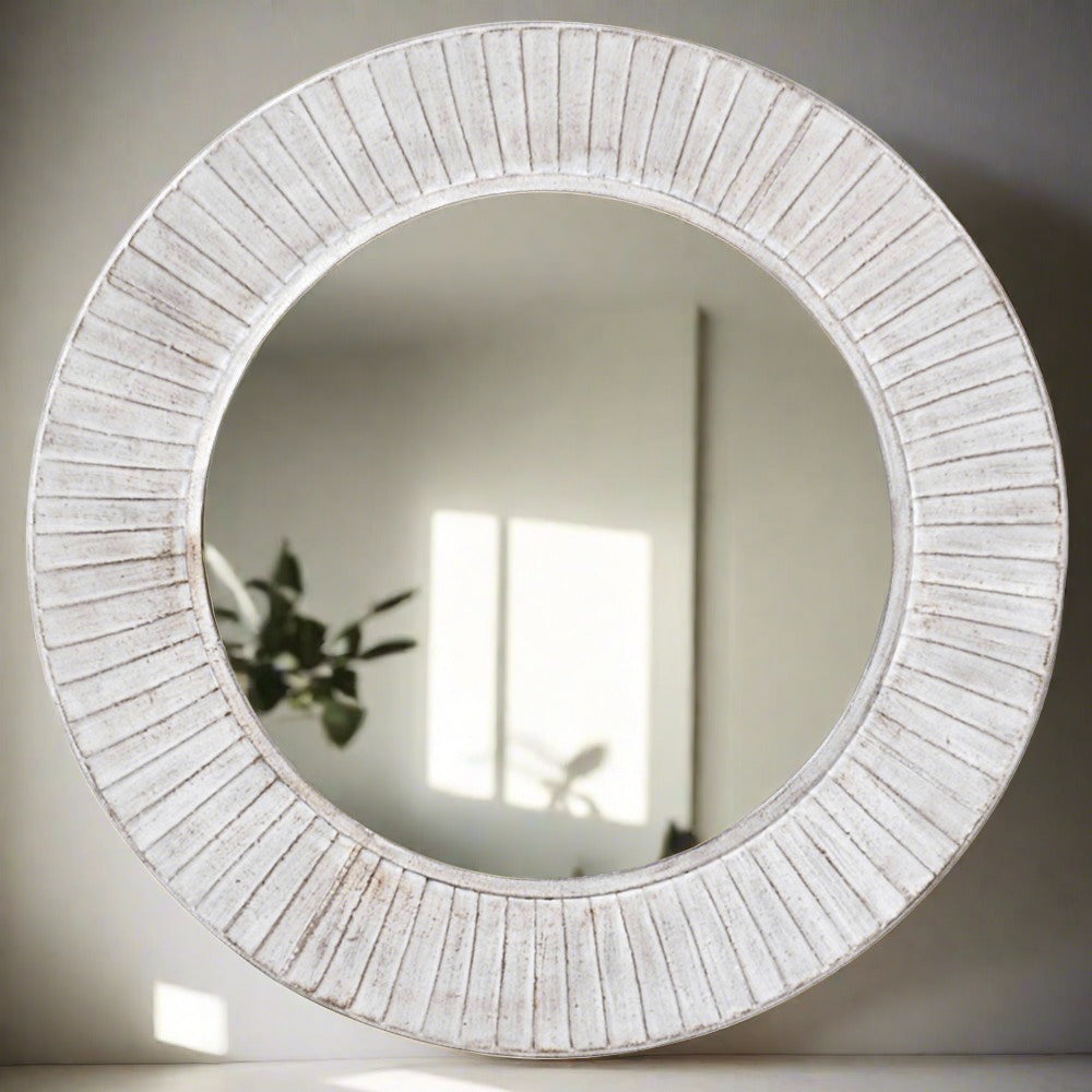A beautiful wooden round mirror in a white wash finish with scallop detailing