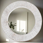 A beautiful wooden round mirror in a white wash finish with scallop detailing