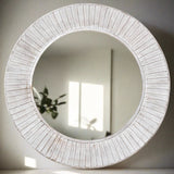 A beautiful wooden round mirror in a white wash finish with scallop detailing