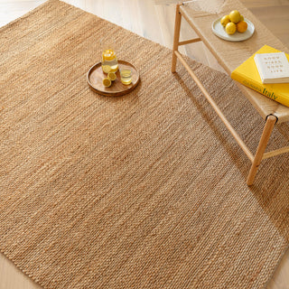 Simplicity handwoven jute rug in natural styled in a living room