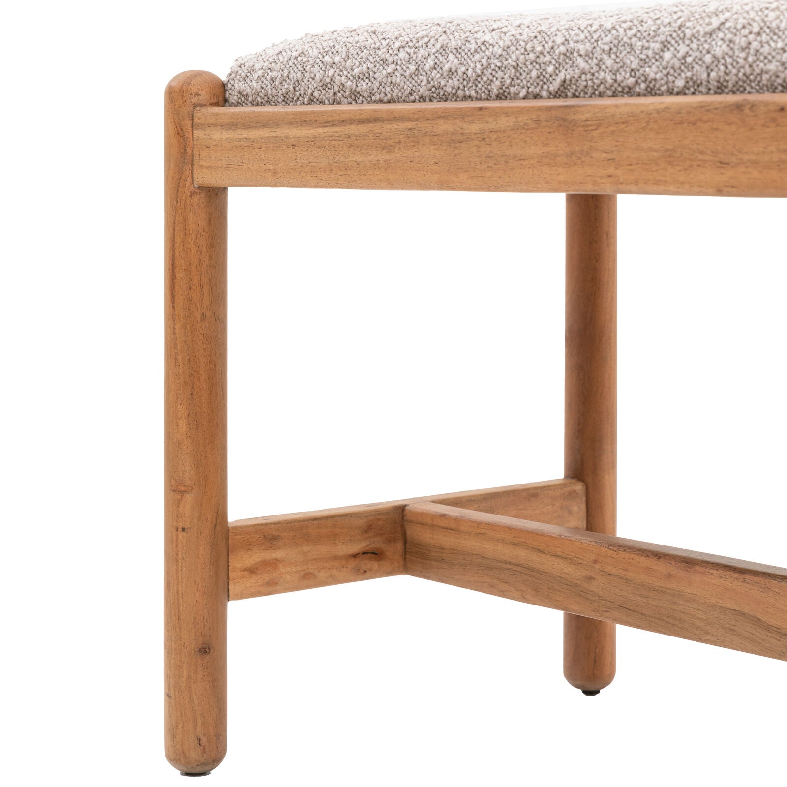 Corner view of solid acacia wood bench with sturdy support frame and boucle cushion