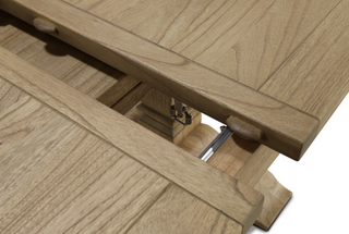 Close-up of the Stourton table's internal butterfly extension mechanism, showing the folding leaf and spring-loaded support