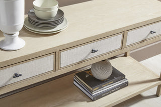 Close-up of the Tranquility console's woven linen-effect drawer fronts and dark metal handles